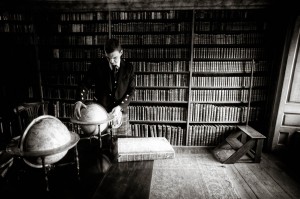 groom in library with globe