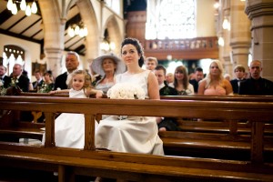 bridesmaids in pew at catholic churchwedding