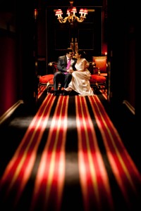 bride and groom with red striped carpet at prestonfield house in edinburgh